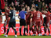 Aberdeen's Ross McCrorie (centre) appeals to referee Grant Irvine after he is sent off following a VAR check. (Photo by Ross Parker / SNS Group)