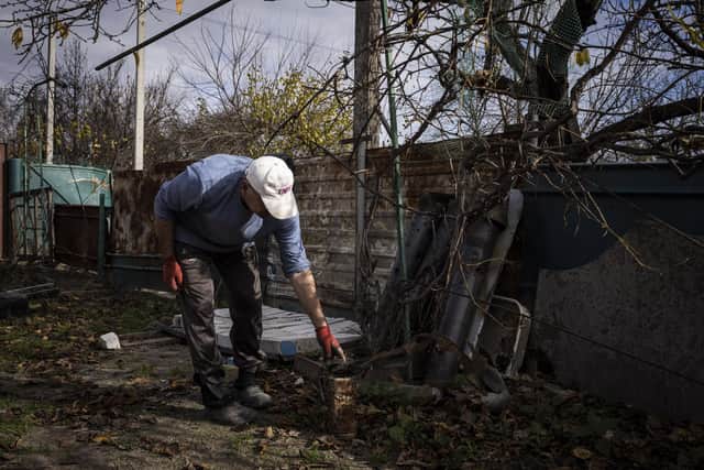 A man moves the remains of a suspected grad rocket in his home that was destroyed by battles at the start of Russia's full scale invasion in Yahidne village on October 30, 2022 in Chernihiv, Ukraine. Photo by Ed Ram/Getty Images