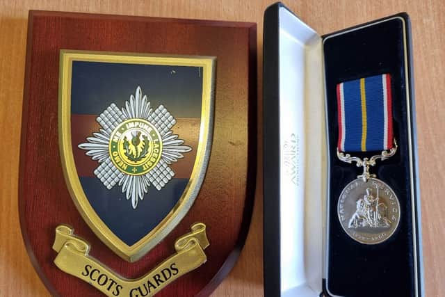 Resident John Ure from HC-One Scotland’s Lunan Court Care Home’s service medal, and plaque