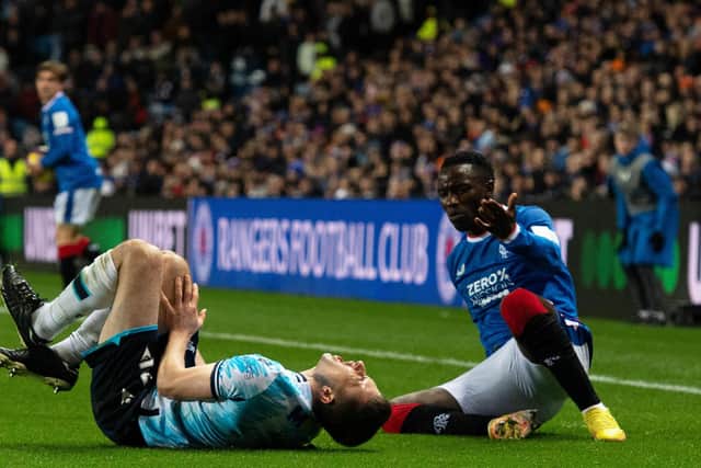 Dundee's Ryan Sweeney reacts after a clash with Rangers winger Fashion Sakala during the Premier Sports Cup quarter-final at Ibrox. (Photo by Paul Devlin / SNS Group)