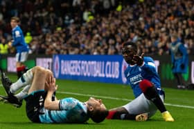 Dundee's Ryan Sweeney reacts after a clash with Rangers winger Fashion Sakala during the Premier Sports Cup quarter-final at Ibrox.  (Photo by Paul Devlin / SNS Group)
