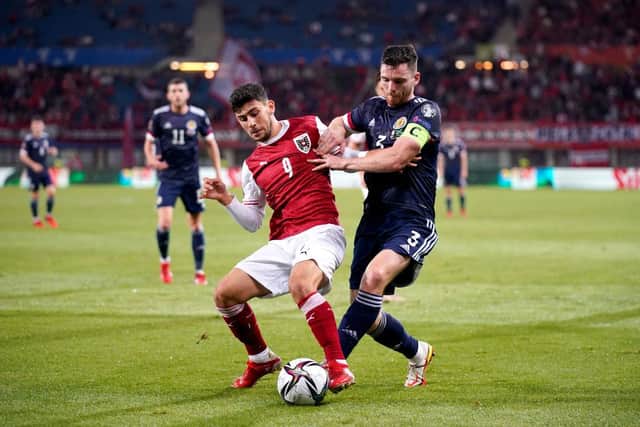 Yusuf Demir of Austria battles for possession with Andy Robertson of Scotland during the 2022 FIFA World Cup Qualifier match between Austria and Scotland at Ernst Happel Stadion on September 07, 2021 in Vienna, Austria. (Photo by Christian Hofer/Getty Images)