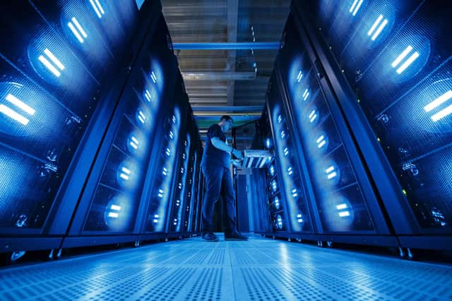 HAMBURG, GERMANY - JUNE 07: An employee of the German Climate Computing Center (DKRZ, or Deutsches Klimarechenzentrum) poses next to the "Mistral" supercomputer, installed in 2016, at the German Climate Computing Center on June 7, 2017 in Hamburg, Germany. The DKRZ provides HPC (high performance computing) and associated services for climate research institutes in Germany. Its high performance computer and storage systems have been specifically selected with respect to climate and Earth system modeling. With a total of 100,000 processor cores, Mistral has a peak performance of 3.6 PetaFLOPS. With a capacity of 54 PBytes, its parallel file system is currently one of the largest in the world. The DKRZ's robot-operated tape archive has currently a capacity of 200 petabytes and allows for long-term archiving of climate simulations such as those carried out with respect to reports by the Intergovernmental Panel on Climate Change. (Photo by Morris MacMatzen/Getty Images)