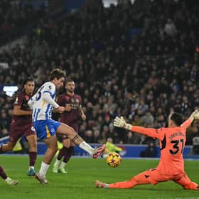 Brighton's Matt O'Riley (C) scores their second goal past Manchester City's Brazilian goalkeeper Ederson.