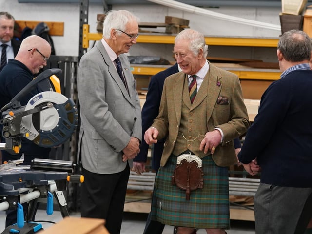 King Charles III enjoys a joke.