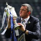 St Johnstone manager Callum Davidson celebrates with the Scottish Cup trophy after the final whistle during the Scottish Cup final match at Hampden Park, Glasgow.