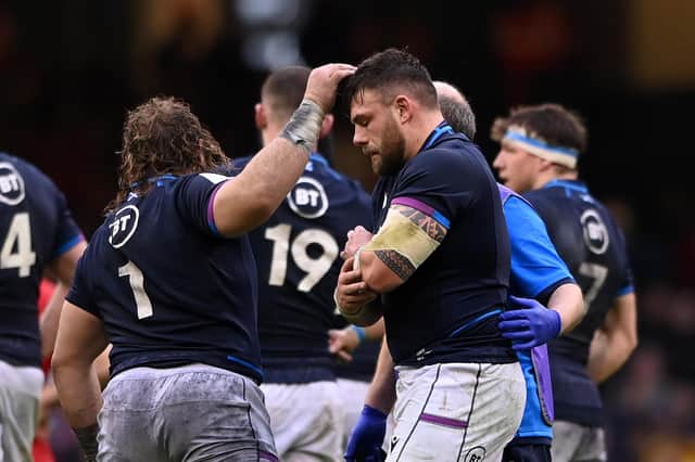Rory Sutherland leaves the field in some discomfort during Scotland's Six Nations clash with Wales.