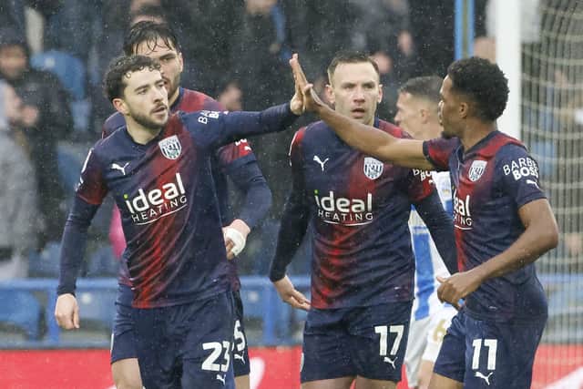 Mikey Johnston, left, celebrates with team-mates after helping West Brom win 4-1 away at Huddersfield.