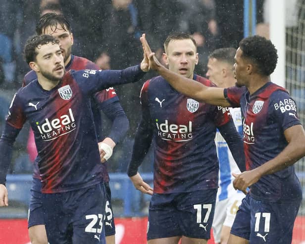 Mikey Johnston, left, celebrates with team-mates after helping West Brom win 4-1 away at Huddersfield.