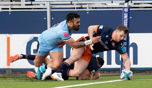 Mark Bennett goes over in the corner to score Edinburgh's third try against Cardiff. (Photo by Ross Parker / SNS Group)