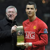 Cristiano Ronaldo poses with his Fifa world player of the year trophy in 2009 alongside the then Manchester United manager Alex Ferguson (Picture: Andrew Yates/AFP via Getty Images)