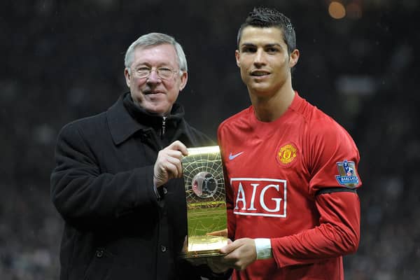 Cristiano Ronaldo poses with his Fifa world player of the year trophy in 2009 alongside the then Manchester United manager Alex Ferguson (Picture: Andrew Yates/AFP via Getty Images)