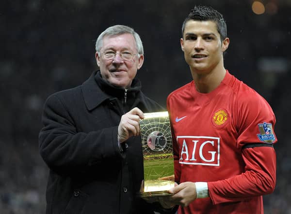 Cristiano Ronaldo poses with his Fifa world player of the year trophy in 2009 alongside the then Manchester United manager Alex Ferguson (Picture: Andrew Yates/AFP via Getty Images)