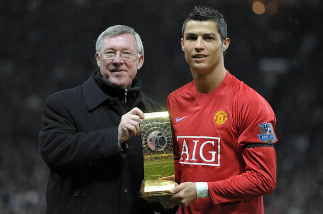 Cristiano Ronaldo poses with his Fifa world player of the year trophy in 2009 alongside the then Manchester United manager Alex Ferguson (Picture: Andrew Yates/AFP via Getty Images)