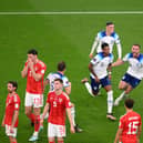 Marcus Rashford of England celebrates with teammates after opening the scoring against Wales.