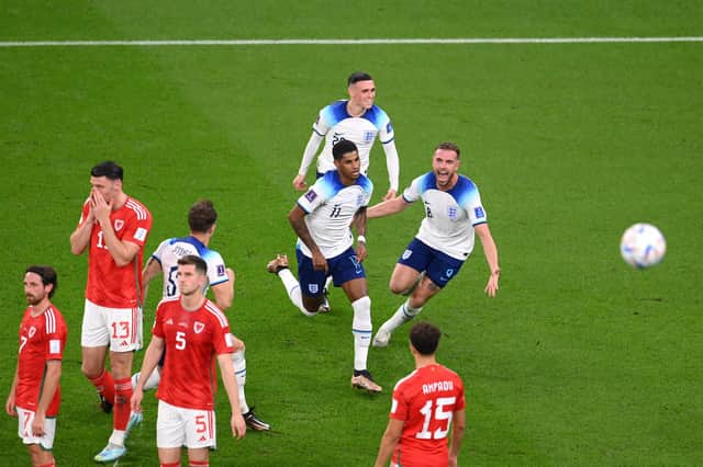 Marcus Rashford of England celebrates with teammates after opening the scoring against Wales.