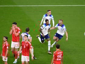 Marcus Rashford of England celebrates with teammates after opening the scoring against Wales.