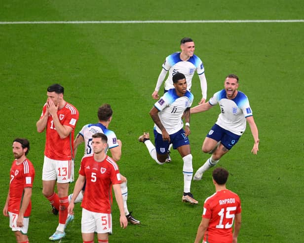 Marcus Rashford of England celebrates with teammates after opening the scoring against Wales.