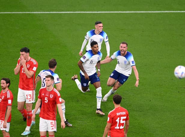 Marcus Rashford of England celebrates with teammates after opening the scoring against Wales.