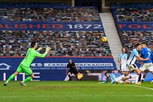 Joe Aribo curls a shot beyond Ross County goalkeeper Ross Laidlaw to make it 3-0 for Rangers at Ibrox. (Photo by Rob Casey / SNS Group)