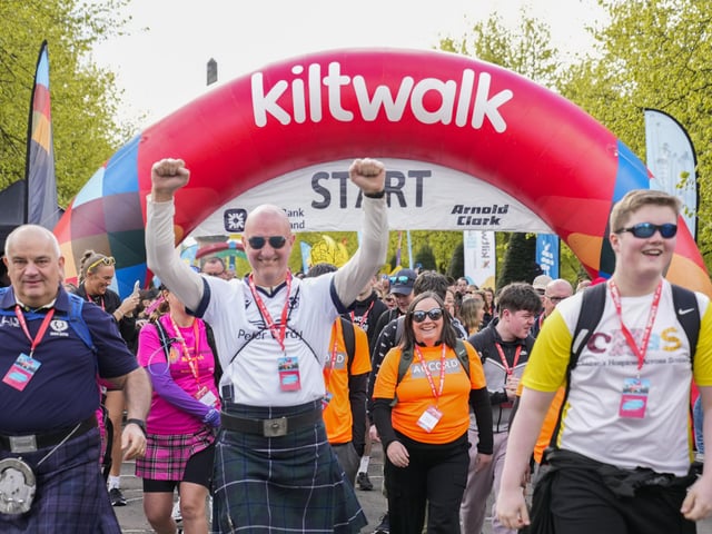 The kilt-clad walkers begin their fundraising adventure.