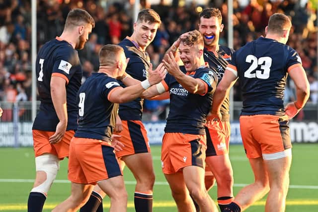 Edinburgh's players relished the atmosphere in their new stadium as they defeated Scarlets 26-22, with Darcy Graham, centre, scoring two tries. Picture: Paul Devlin/SNS