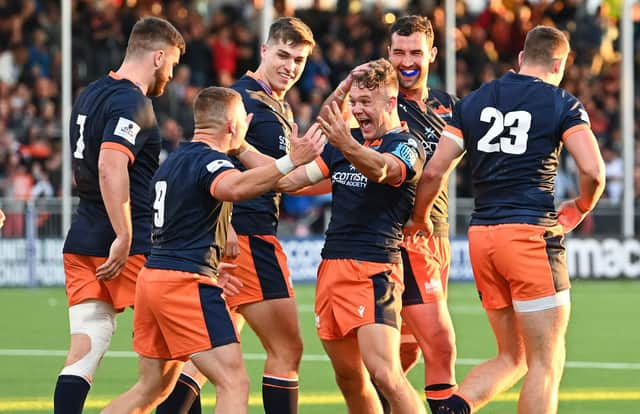 Edinburgh's players relished the atmosphere in their new stadium as they defeated Scarlets 26-22, with Darcy Graham, centre, scoring two tries. Picture: Paul Devlin/SNS