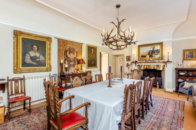The grand formal dining room has period features and ample space.