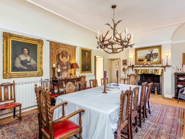 The grand formal dining room has period features and ample space.