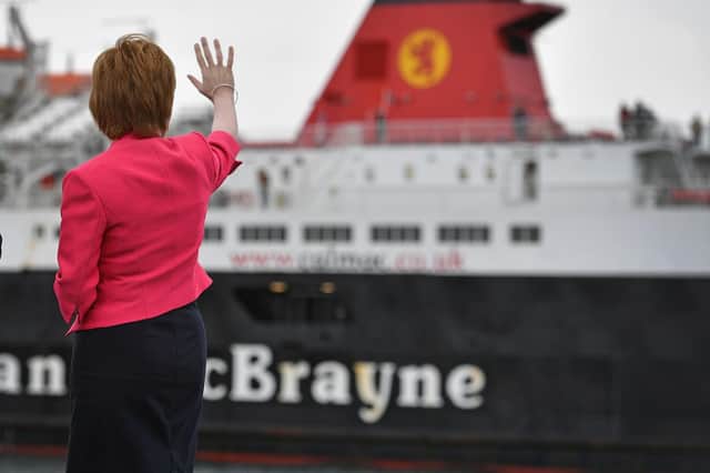 Nicola Sturgeon waves at a Calmac ferry at Ardrossan harbour (Picture: Jeff J Mitchell/pool/Getty Images)