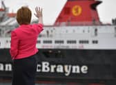 Nicola Sturgeon waves at a Calmac ferry at Ardrossan harbour (Picture: Jeff J Mitchell/pool/Getty Images)