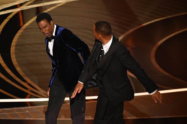US actor Will Smith (R) slaps US actor Chris Rock onstage during the 94th Oscars at the Dolby Theatre in Hollywood, California on March 27, 2022. (Image credit: Robyn Beck/AFP via Getty Images)