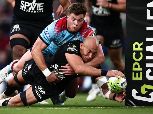 Huw Jones is unable to prevent Toulon's Italian No 8 Sergio Parisse scoring the French club's second try in the 43-19 Challenge Cup final win. (Photo by Anne-Christine Poujoulat/AFP via Getty Images)