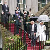 King Charles III, Queen Camilla and the Princess Royal (behind), pause on the steps for the National Anthem, as they host guests for a Garden Party at the Palace of Holyroodhouse. Picture: Jonathan Brady - WPA Pool/Getty Images