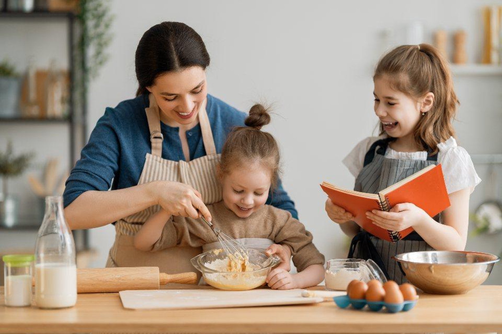 A Mom Cooking With Her Two Daughters