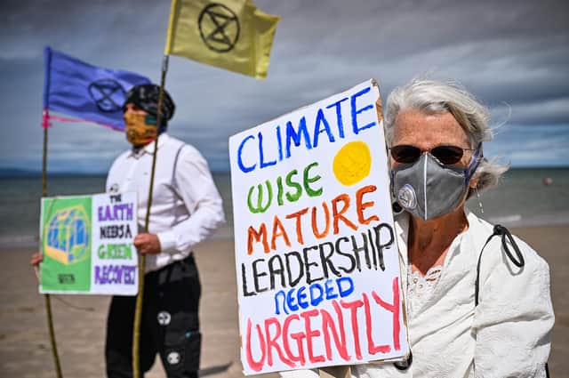 Members of Extinction Rebellion hold a demonstration on Central Beach in Nairn. But investors, including anyone with a pension, can help change the world too (Picture: Jeff J Mitchell/Getty Images)