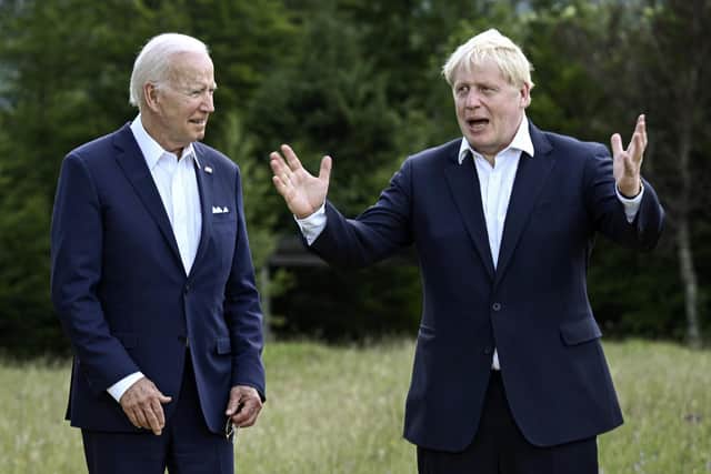 US president Joe Biden and Britain's Prime Minister Boris Johnson, right, chat as they gather for a group photo at Castle Elmau in Kruen, near Garmisch-Partenkirchen, Germany, on Sunday. Picture: Brendan Smialowski/Pool via AP