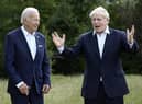 US president Joe Biden and Britain's Prime Minister Boris Johnson, right, chat as they gather for a group photo at Castle Elmau in Kruen, near Garmisch-Partenkirchen, Germany, on Sunday. Picture: Brendan Smialowski/Pool via AP