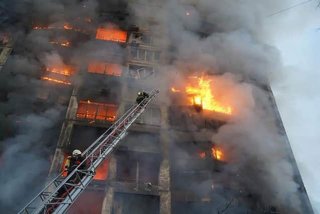 Strikes on residential areas in Kyiv killed at least two people early on March 15, emergency services said, as Russian troops intensified their attacks on the Ukrainian capital. (Photo by State Emergency Service of Ukraine / AFP)