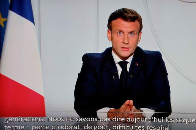 French President Emmanuel Macron is seen on a TV screen in Paris on October 28, 2020, as he delivers an evening televised address to the nation, to announce new measures aimed curbing the spread of the Covid-19 pandemic. (Photo by LUDOVIC MARIN/AFP via Getty Images)