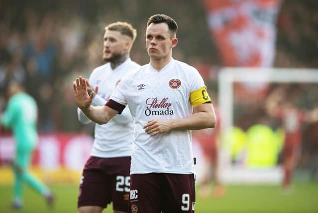 Hearts striker Lawrence Shankland has been called into the Scotland squad.