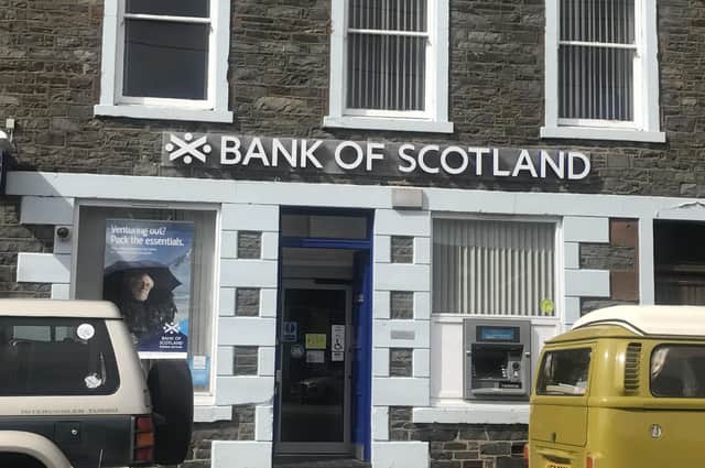 Bank of Scotland owner Lloyds Banking Group saw its pre-tax profits almost wiped out after taking a major hit from worsening economic conditions in the first three months of the year.