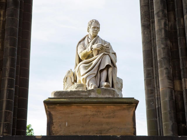 Beneath which monument would you find this fine statue? An extra point if you can identify the man and his dog.