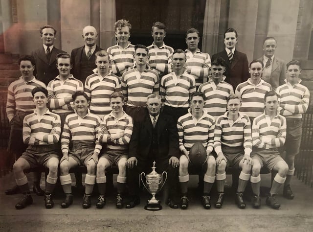 Captain Davie Rose, holding the ball, with Jed Thistle teammates and officials