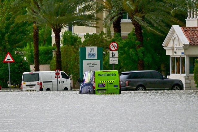 Vehicles are stranded on a flooded street following torrential rain in the Gulf Emirate of Dubai.