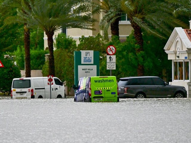 Vehicles are stranded on a flooded street following torrential rain in the Gulf Emirate of Dubai.