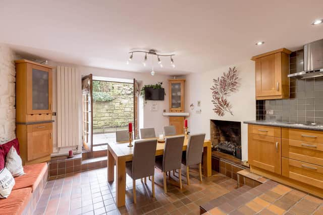 The flat’s dining area with fireplace focal point affords access to a private rear garden. Picture: Alan Rennie Photography