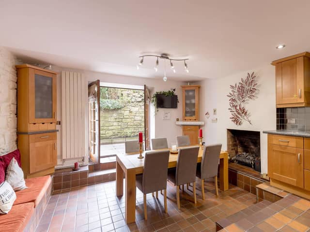 The flat’s dining area with fireplace focal point affords access to a private rear garden. Picture: Alan Rennie Photography