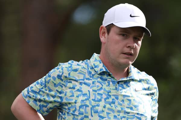 Before being forced to withdraw, Bob MacIntyre holds his back in discomfort during the third round of the BMW Championship at Castle Pines Golf Club in Colorado. Picture: Harry How/Getty Images.