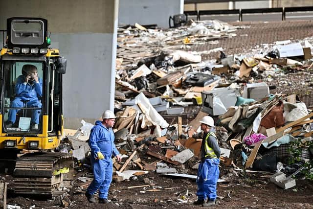 Organised crime groups are suspected of quietly dumping a mountain of refuse under the M8 motorway, including fridges, washing machines, baths, toilets, rotting bin bags and hazardous building waste.